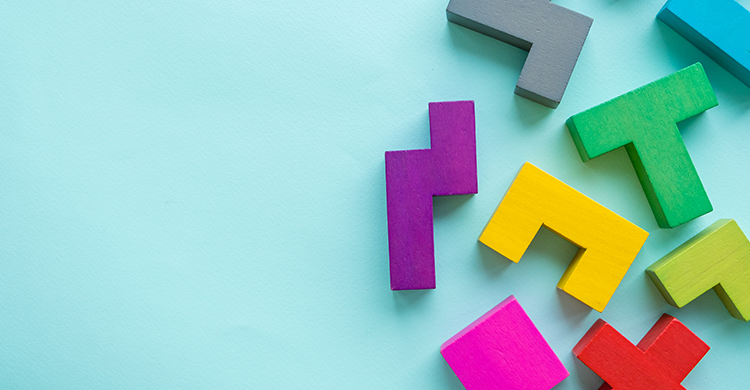 Colorful puzzle blocks covering the right side of the image, set against a sky blue backdrop.